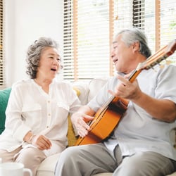 A couple singing and playing guitar 